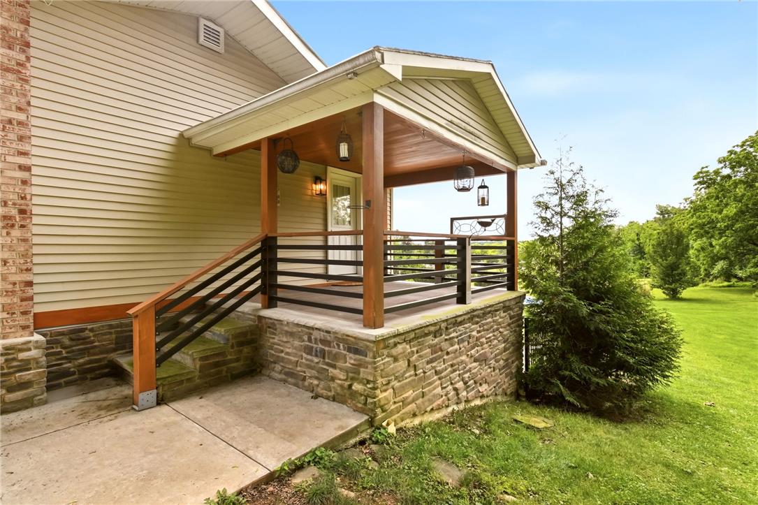 463 North Penn Dixie Road Bath, PA 18014 - Photo 7 of 86 A welcoming front porch, accented by rustic stone and wood elements, invites peaceful outdoor enjoyment.