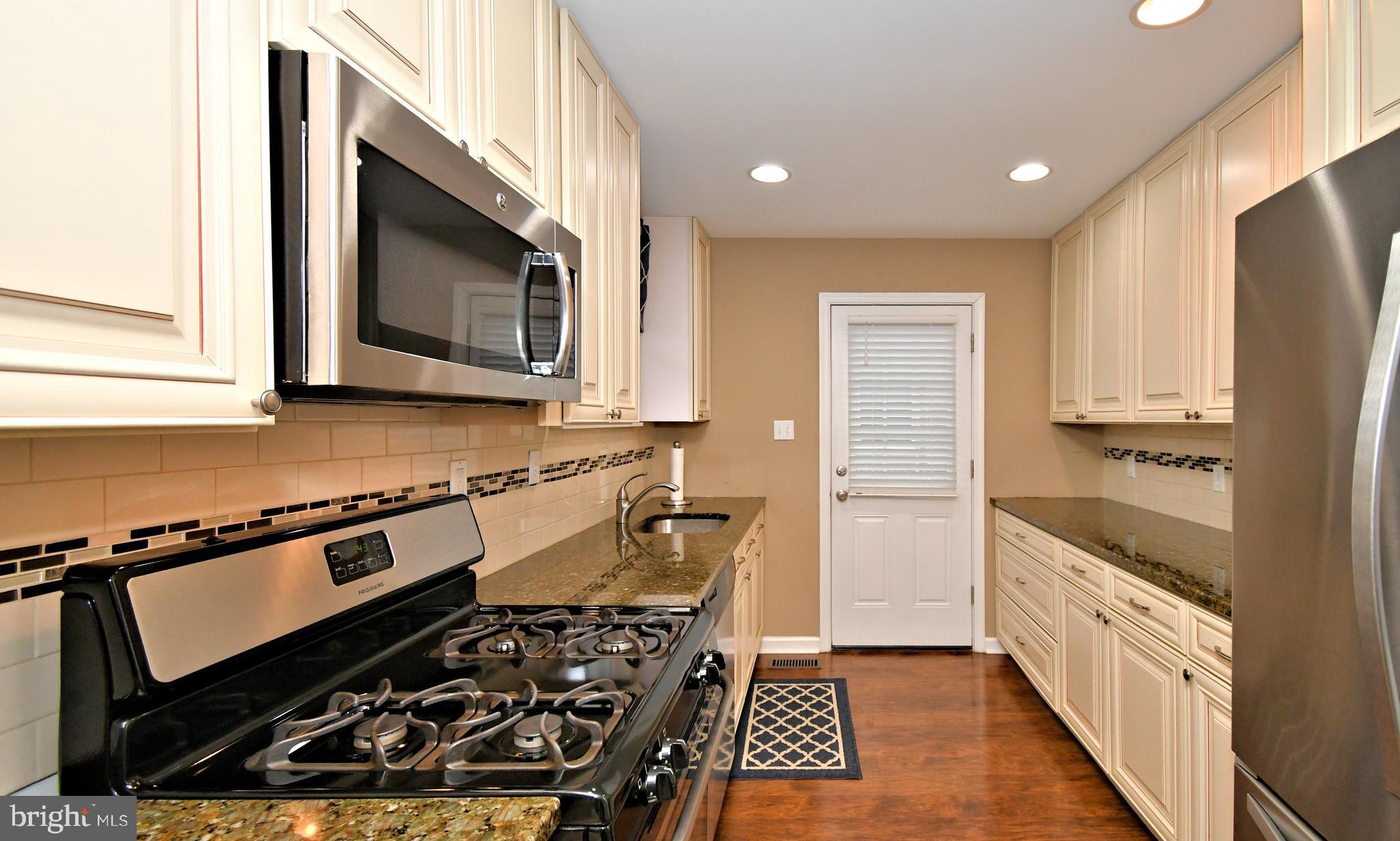 701 Cypress Road Warminster, PA 18974 - Photo 15 of 52 a kitchen with wooden cabinets and a stove top oven