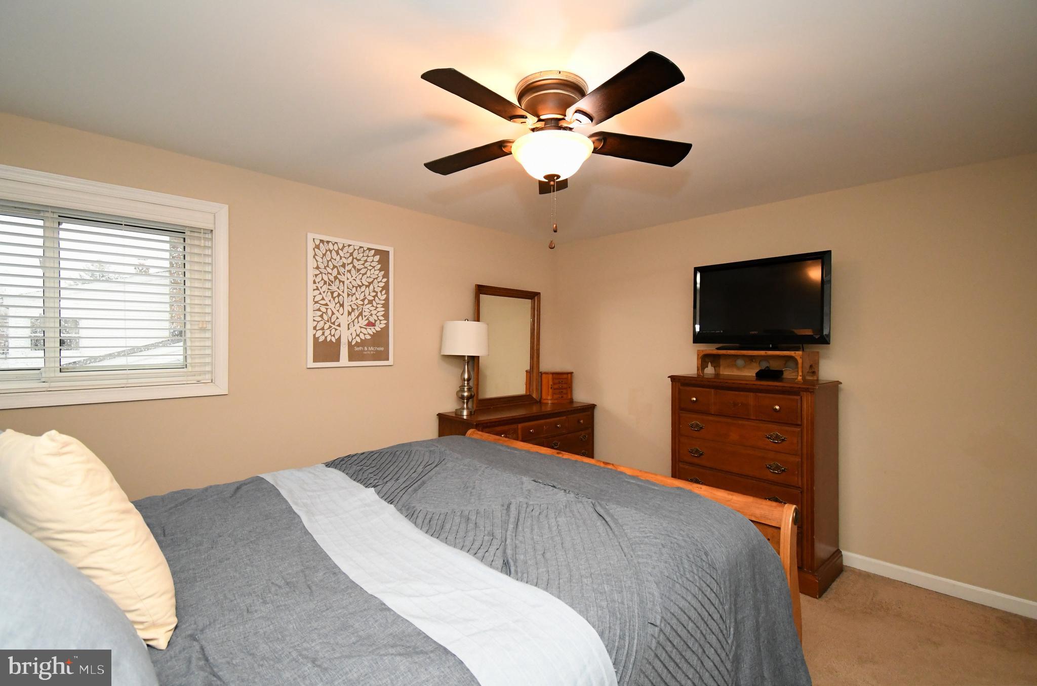 701 Cypress Road Warminster, PA 18974 - Photo 25 of 52 a bedroom with a bed and a flat screen tv