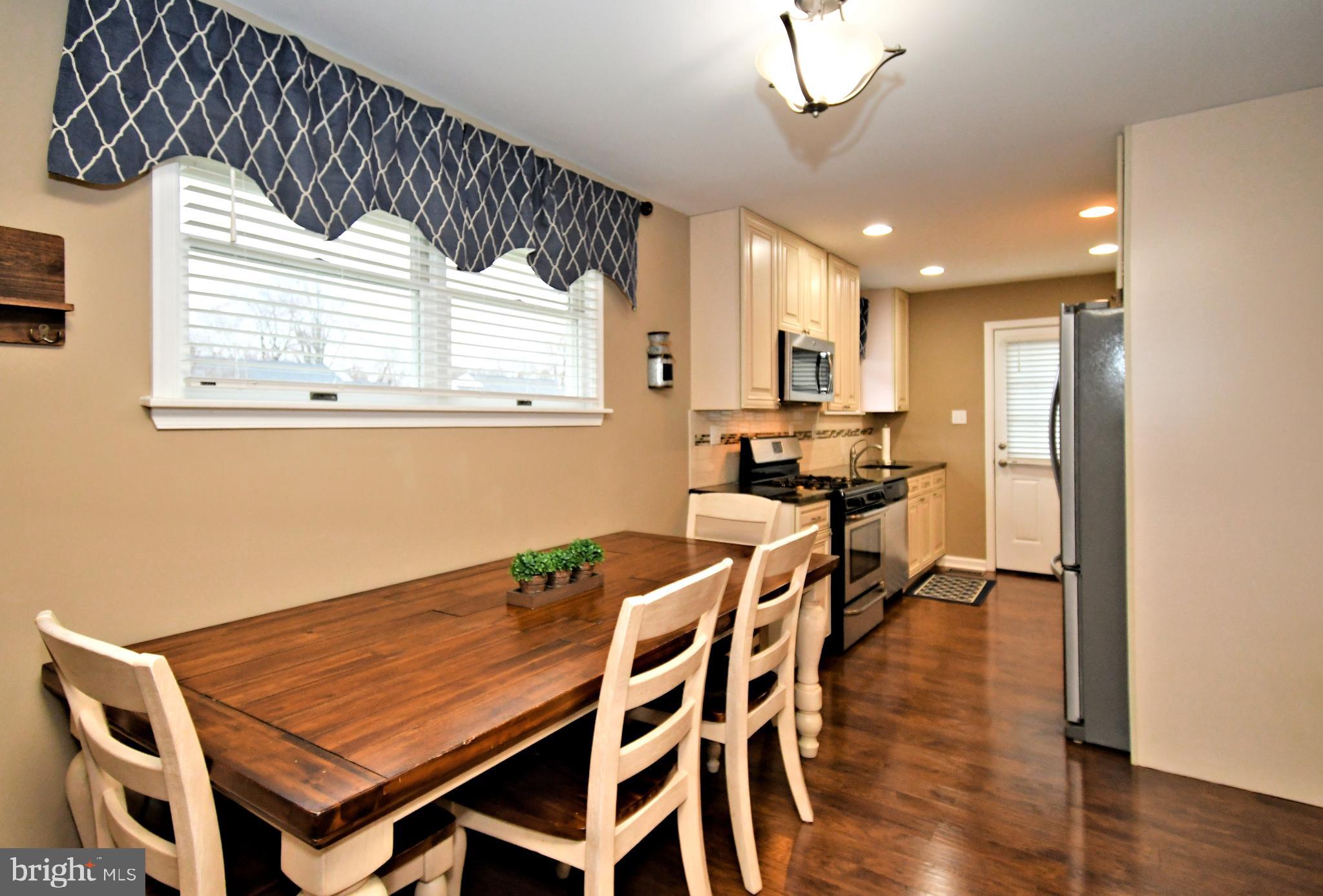 701 Cypress Road Warminster, PA 18974 - Photo 10 of 52 a view of a dining room with furniture and wooden floor