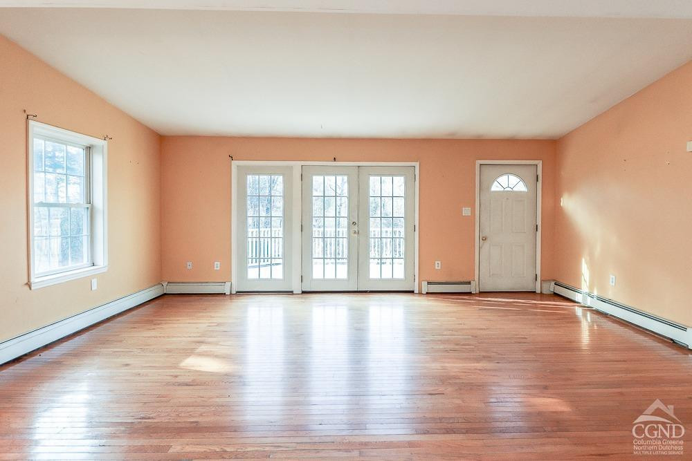 149 Spring Road Hudson, NY 12534 - Photo 4 of 30 a view of an empty room with glass door and wooden floor