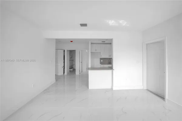 a view of a hallway with a kitchen