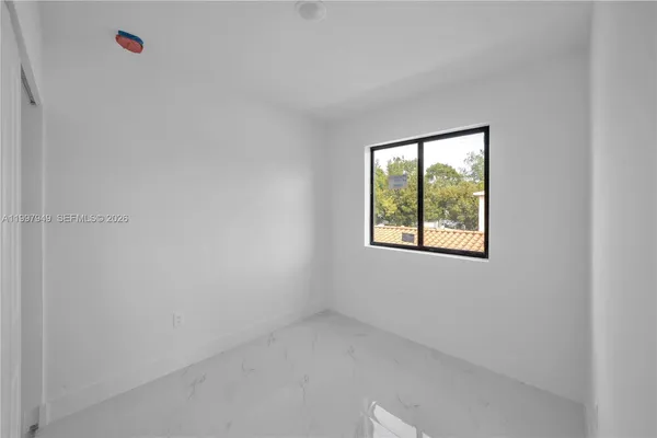 a view of an empty room with a window