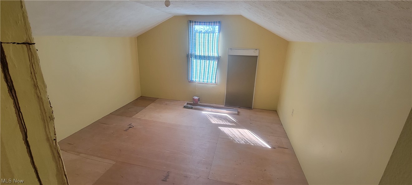 12399 Old State Road Chardon, OH 44024 - Photo 19 of 21 Additional living space featuring lofted ceiling and a textured ceiling