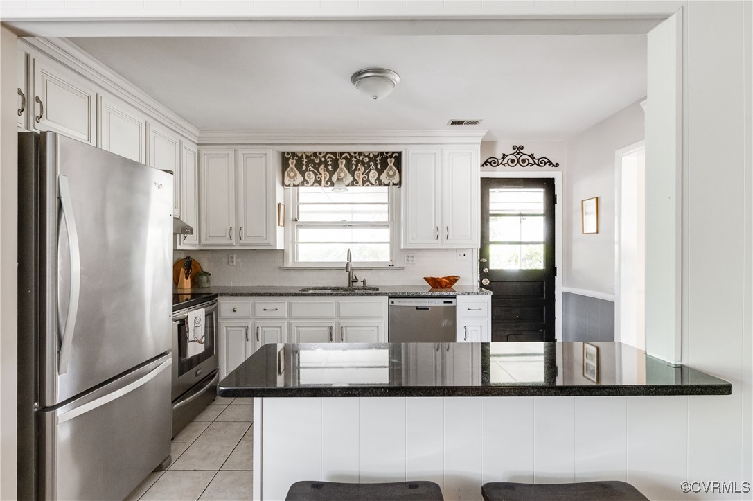 208 Tamarack Road Henrico, VA 23229 - Photo 12 of 35 a kitchen with stainless steel appliances granite countertop a refrigerator sink and stove