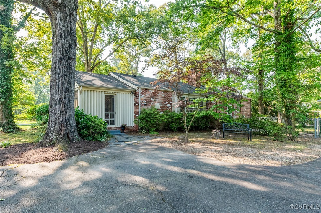 208 Tamarack Road Henrico, VA 23229 - Photo 4 of 35 a backyard of a house with plants and large trees