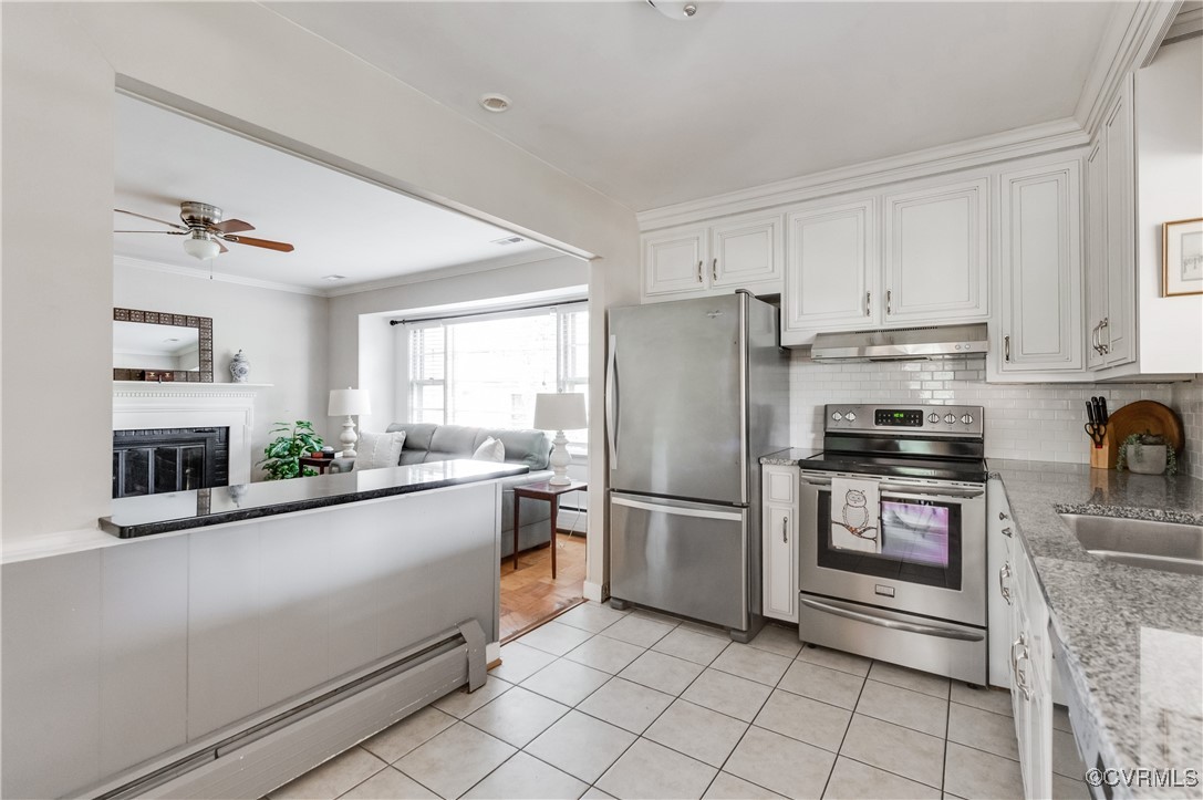 208 Tamarack Road Henrico, VA 23229 - Photo 8 of 35 a kitchen with granite countertop a refrigerator and a stove top oven