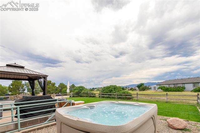 11170 Peaceful Valley Road Colorado Springs, CO 80925 - Photo 9 of 49 View of swimming pool featuring a hot tub and a gazebo