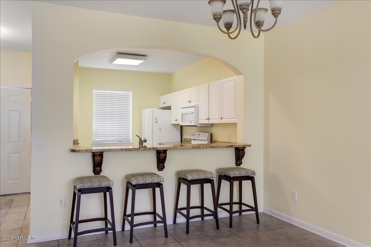 3112 Haley Pointe Road St. Augustine, FL 32084 - Photo 4 of 23 a kitchen with stainless steel appliances a white table chairs and a refrigerator