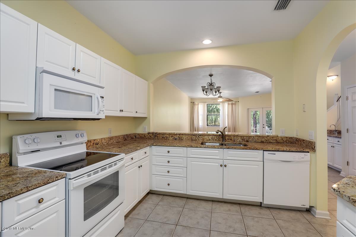 3112 Haley Pointe Road St. Augustine, FL 32084 - Photo 5 of 23 a kitchen with granite countertop white cabinets white stainless steel appliances with a sink and dishwasher