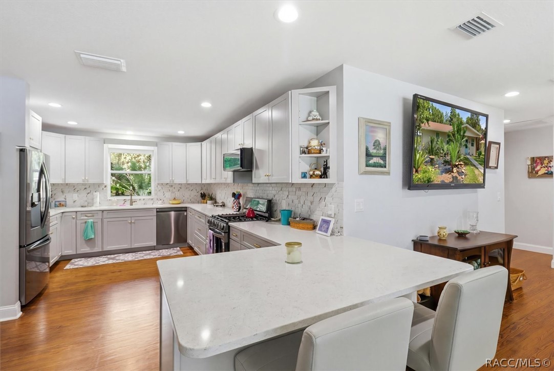 4099 West Ridge Court Dunnellon, FL 34433 - Photo 17 of 49 Gourmet kitchen with newer wood cabinets w/soft close doors. Quartz counters. recessed lighting. Gas range, Microwave hood, dishwasher & awesome refigerator. Perfect for entertaining or large family gatherings!