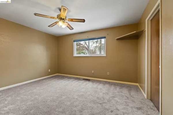 a view of room with window and ceiling fan