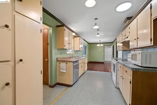 a kitchen with stainless steel appliances granite countertop a sink a stove and a refrigerator