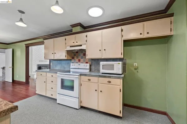 a kitchen with cabinets and white appliances