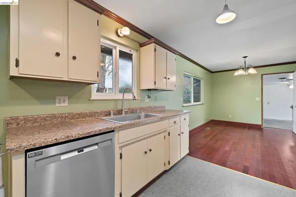 a kitchen that has a sink and a stove in it