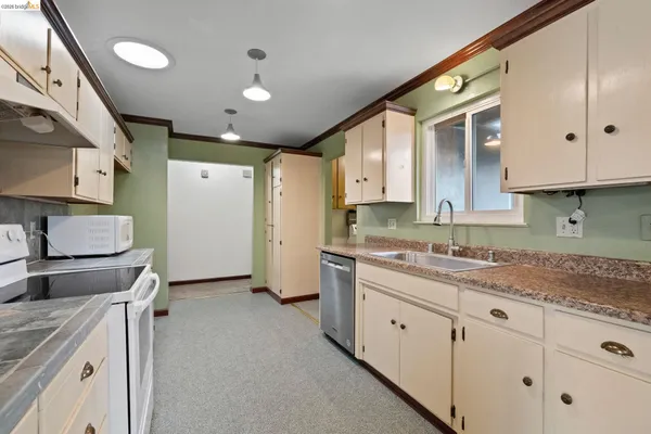 a kitchen with a sink stove and cabinets
