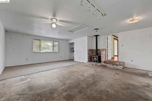 a view of a livingroom with a ceiling fan and window