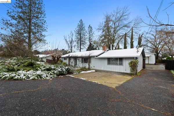 a view of a house with a yard and sitting area