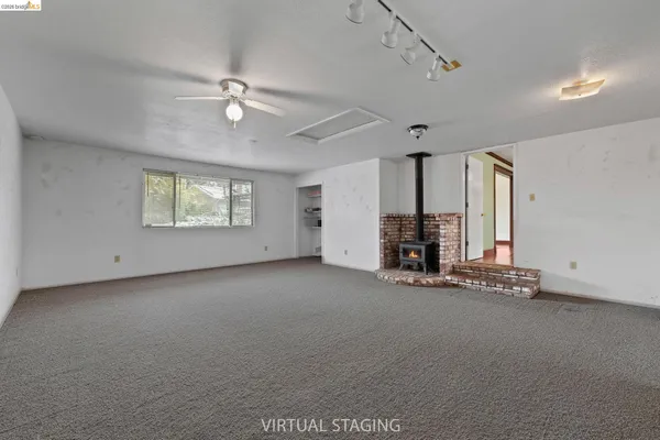 a view of a livingroom with fireplace and window
