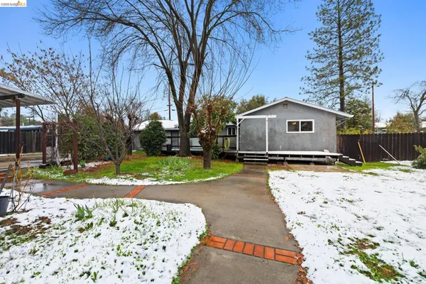 a view of a chair and table in front of house