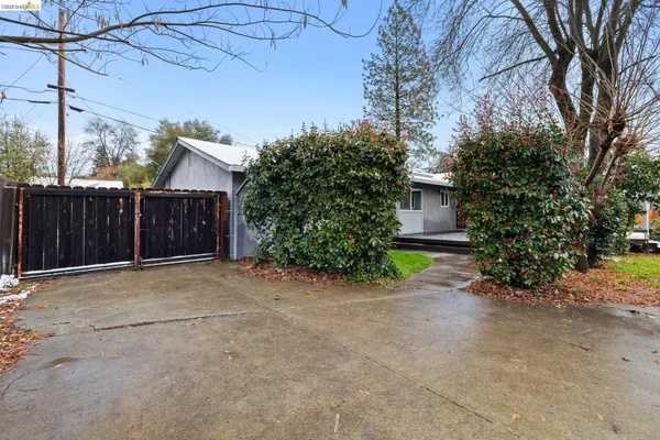 a view of a house with a yard and garage