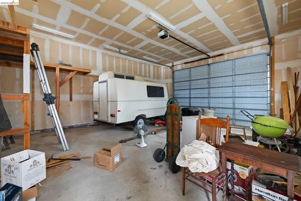 a view of a patio with table and chairs with wooden fence