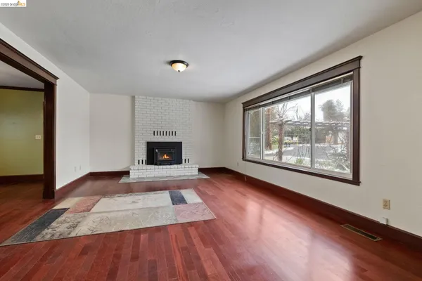 wooden floor in an empty room with a fireplace