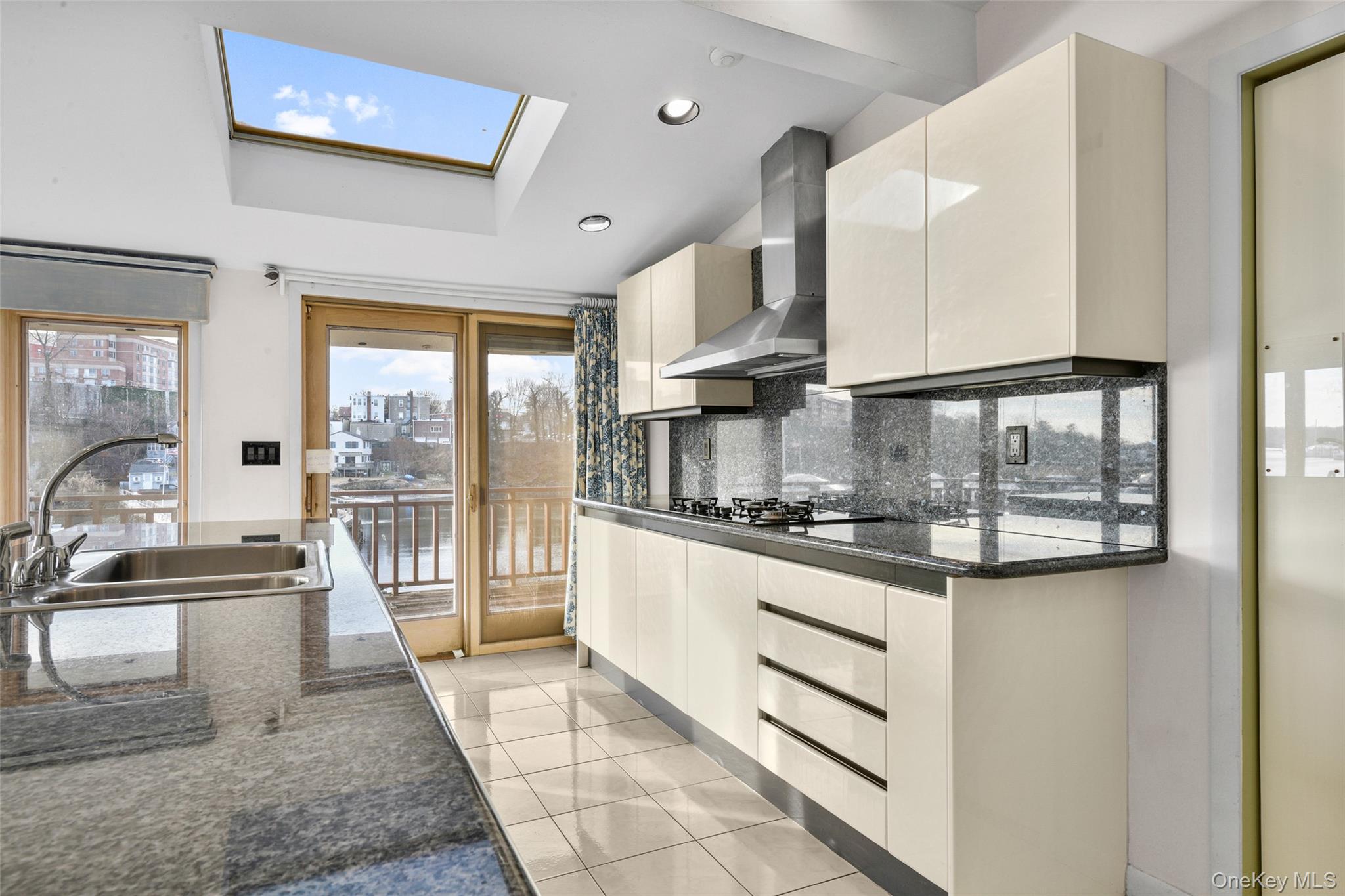 31 Clover Place New Rochelle, NY 10805 - Photo 13 of 44 a kitchen with stainless steel appliances granite countertop a stove a sink and a granite counter tops with white cabinets
