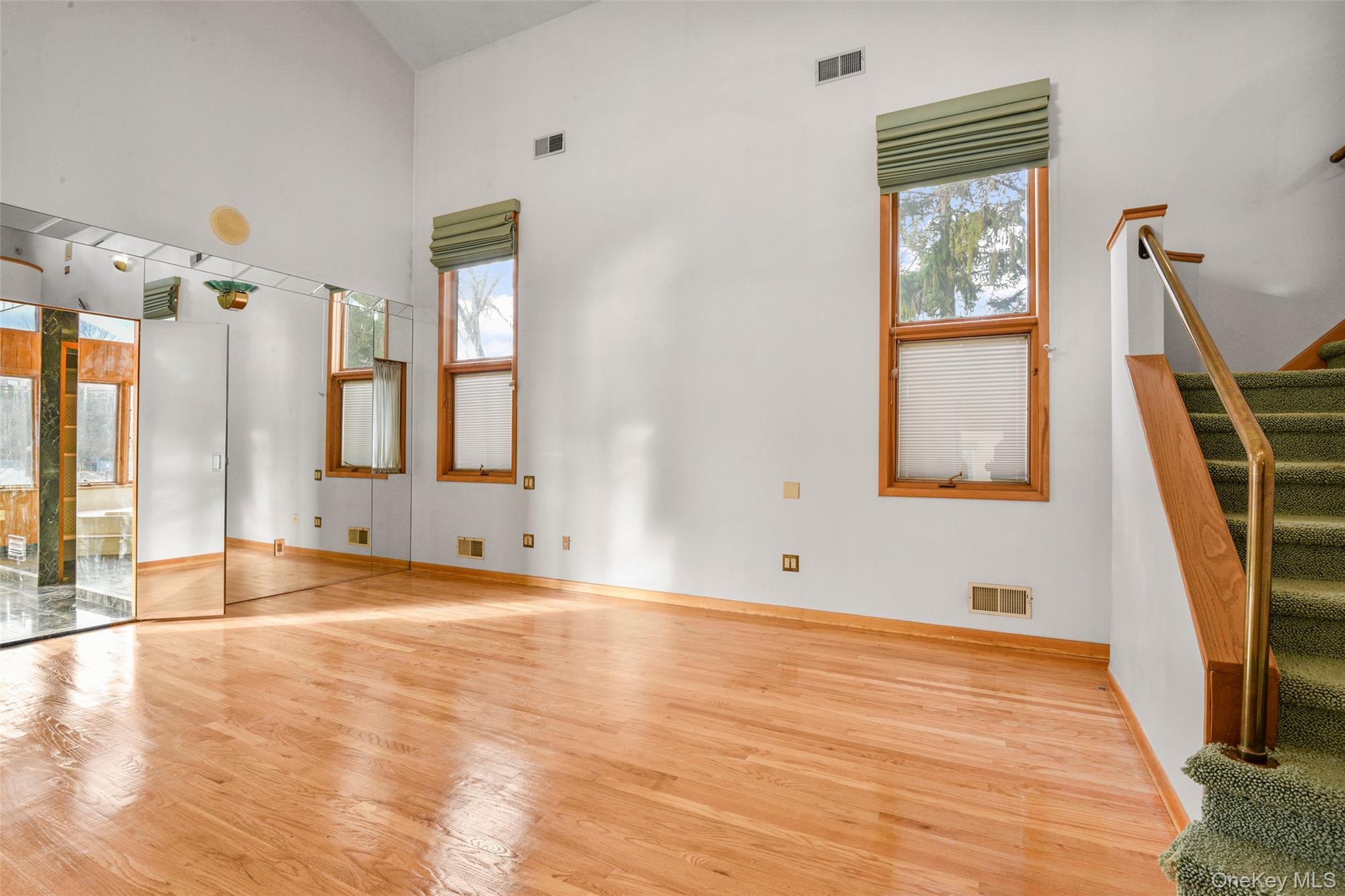 31 Clover Place New Rochelle, NY 10805 - Photo 17 of 44 a view of an empty room with wooden floor and a window