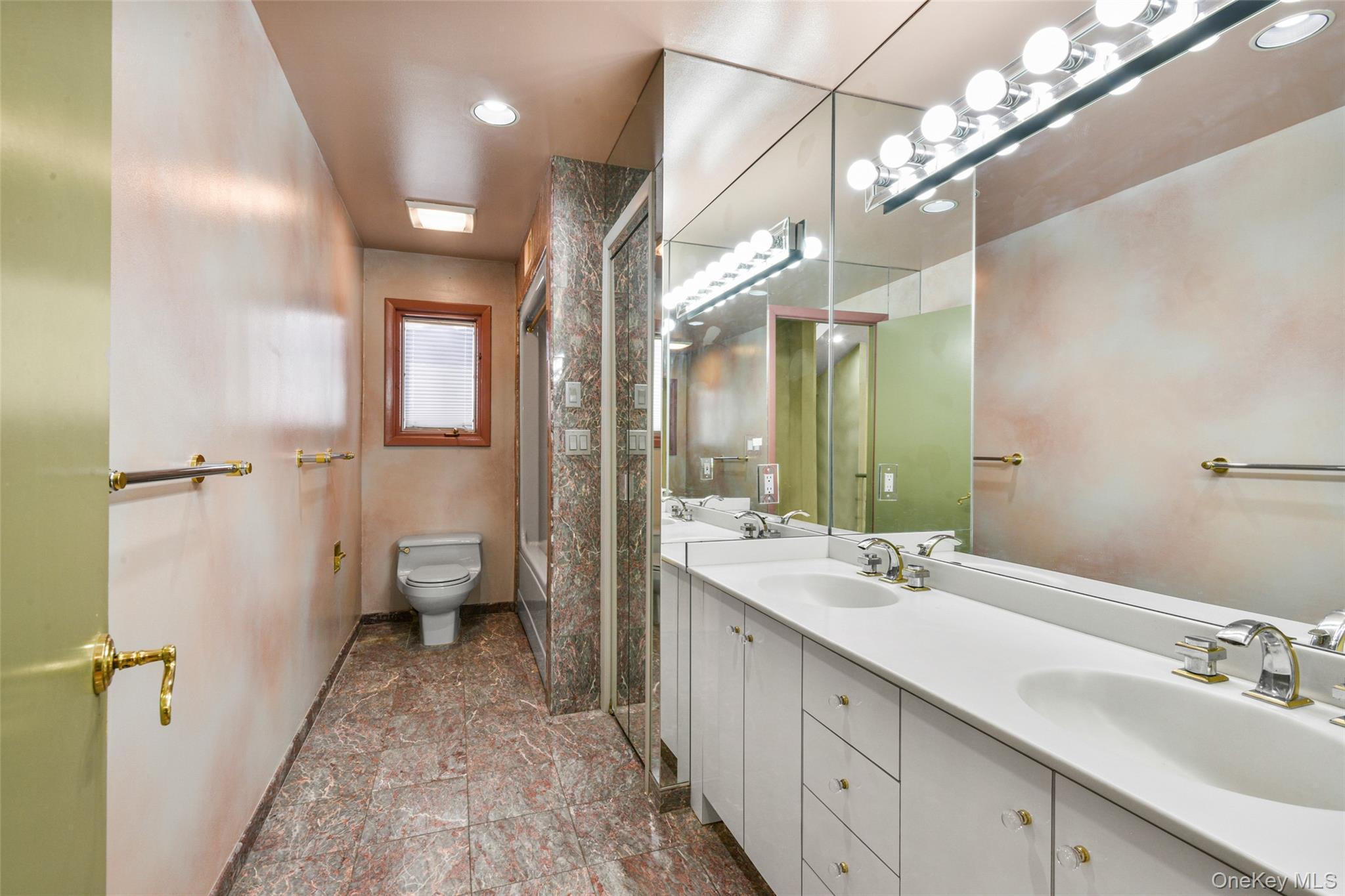 31 Clover Place New Rochelle, NY 10805 - Photo 27 of 44 a spacious bathroom with a double vanity sink a large mirror and a shower