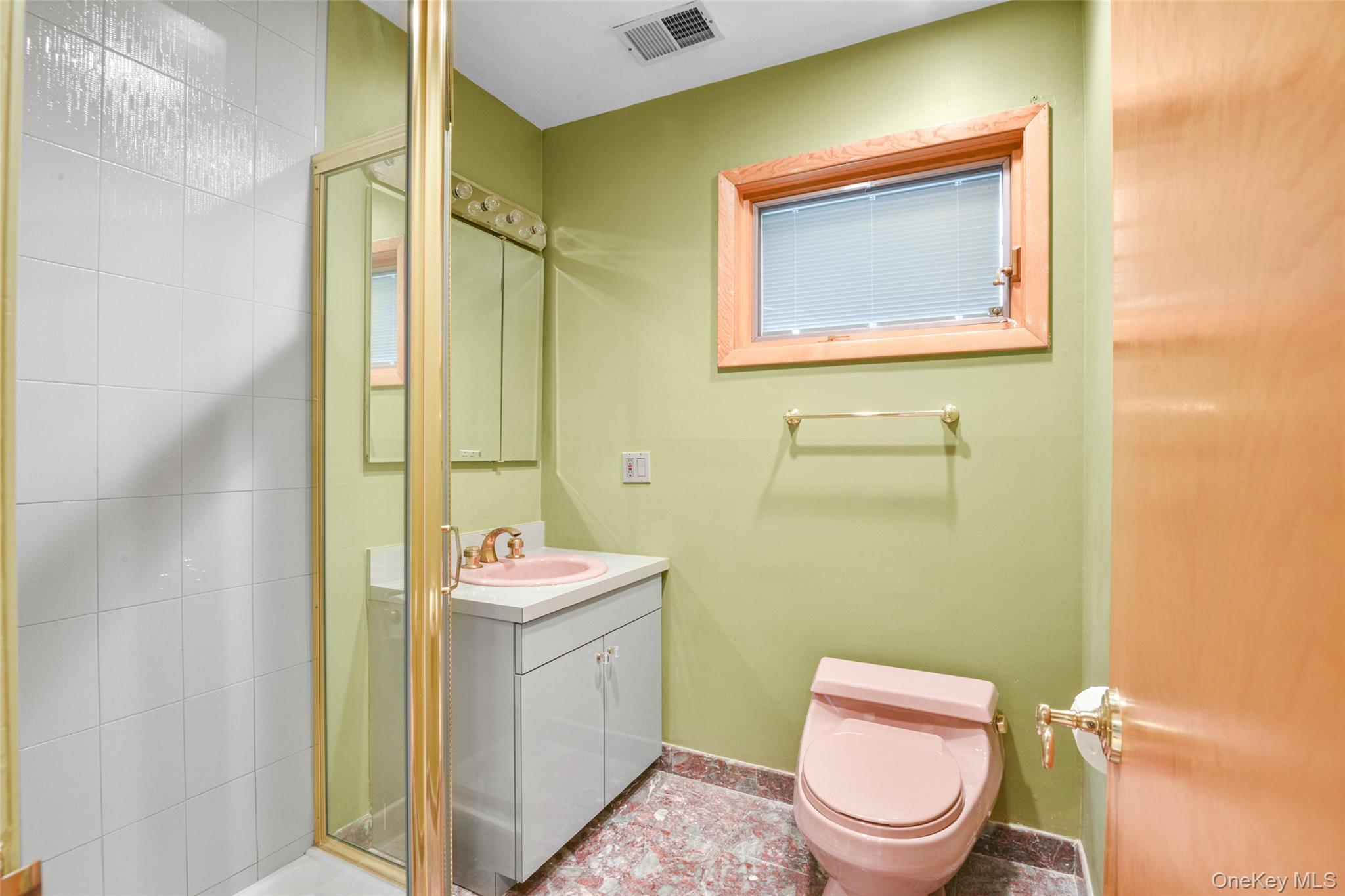 31 Clover Place New Rochelle, NY 10805 - Photo 33 of 44 a bathroom with a toilet sink vanity and mirror