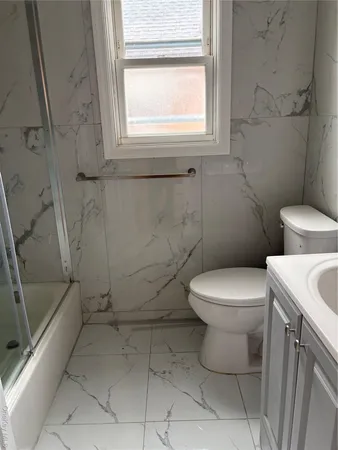 a white toilet sitting next to a bathroom sink