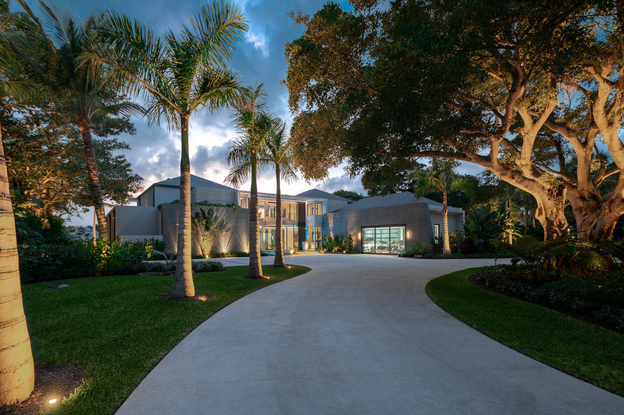 488 South Beach Road Jupiter Island, FL 33455 - Photo 51 of 54 front view of a house with a yard and palm trees