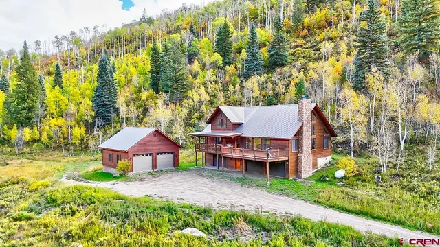 a view of a house with a yard and sitting area