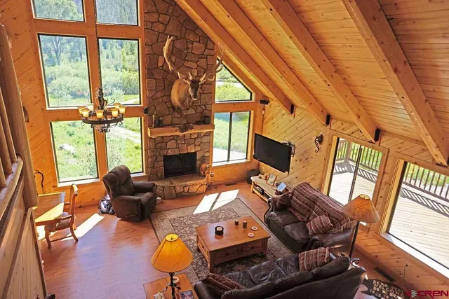 a living room with furniture fireplace and a large window