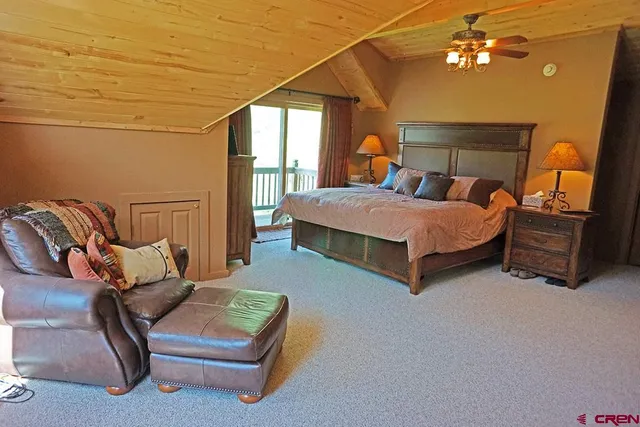 a bedroom with a bed chair and window