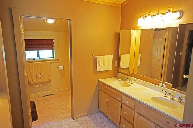 a bathroom with a double vanity sink and a mirror