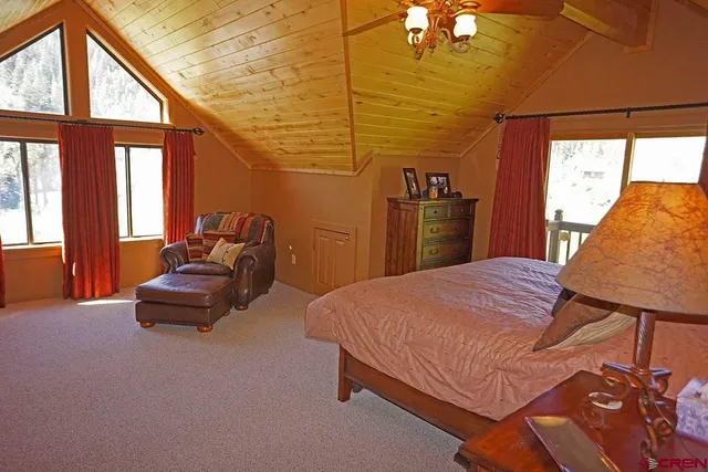 a bedroom with a bed and a large window