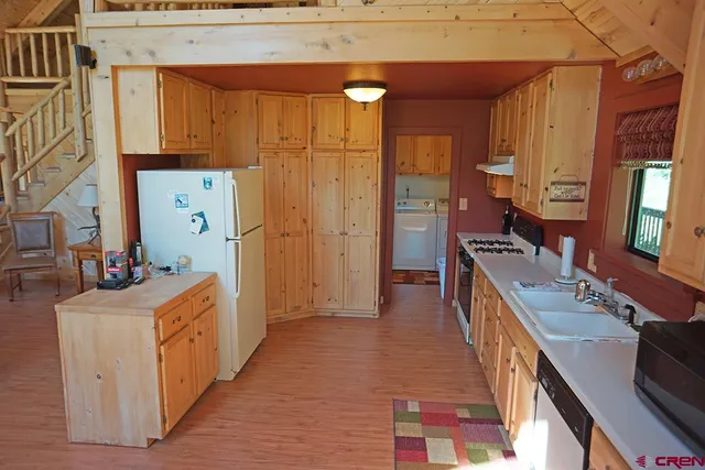 a kitchen with a sink stove and a refrigerator