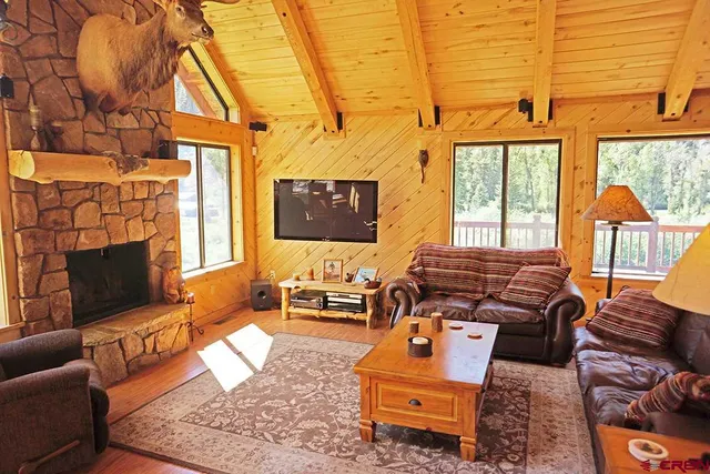 a living room with furniture a rug and a fireplace