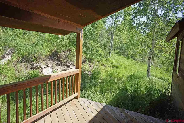 a view of a balcony with wooden floor