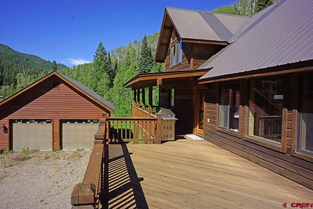 a view of a lush green hillside and houses
