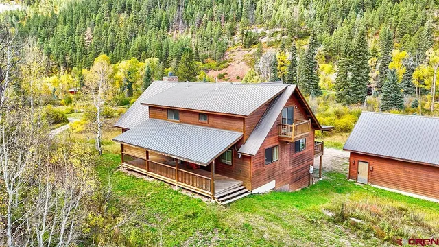 an aerial view of a house with a yard