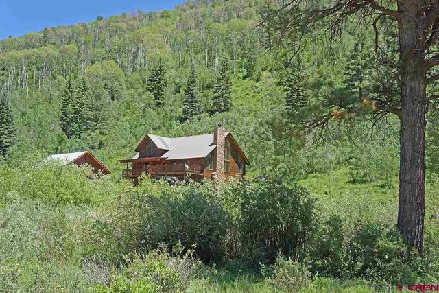an aerial view of a house with yard and outdoor seating