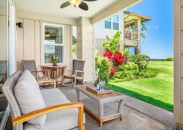 a view of a patio with couches chairs potted plants and floor to ceiling window