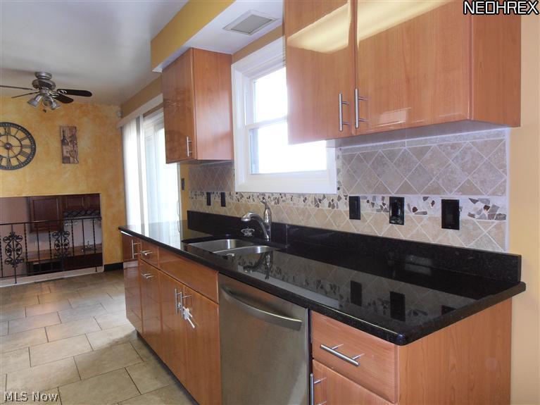 995 Millridge Road Cleveland, OH 44143 - Photo 3 of 17 Granite counter tops and ceramic tile flooring - opens to Family Room