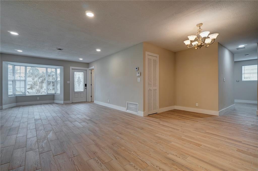 6711 Northwest 8th Street Margate, FL 33063 - Photo 11 of 25 a view of empty room with wooden floor and fan