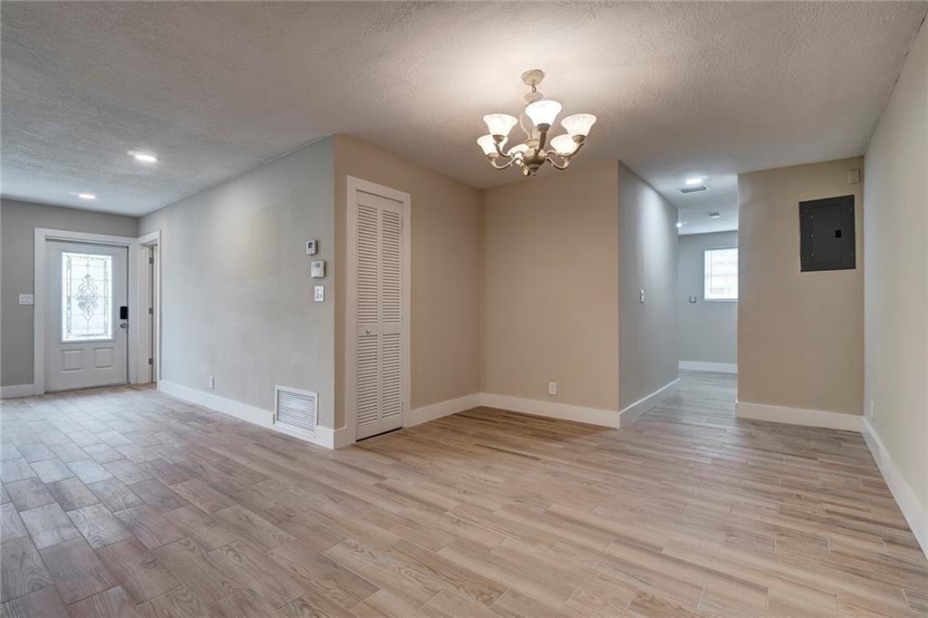 6711 Northwest 8th Street Margate, FL 33063 - Photo 13 of 25 a view of an empty room with wooden floor and staircase