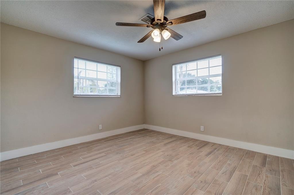 6711 Northwest 8th Street Margate, FL 33063 - Photo 19 of 25 wooden floor in an empty room with a window