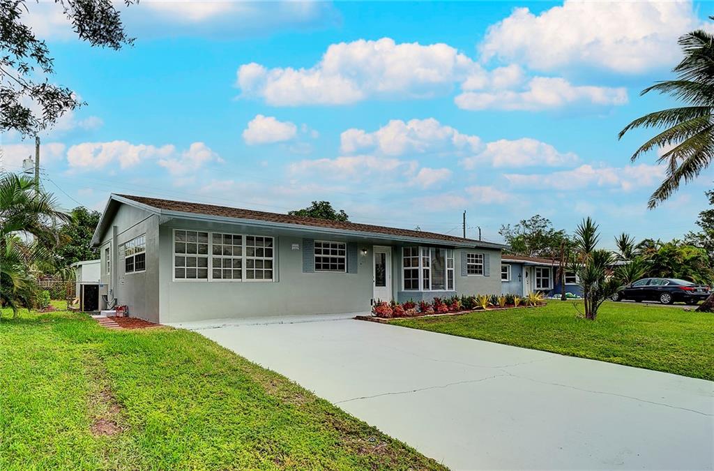 6711 Northwest 8th Street Margate, FL 33063 - Photo 2 of 25 a front view of house with yard and green space